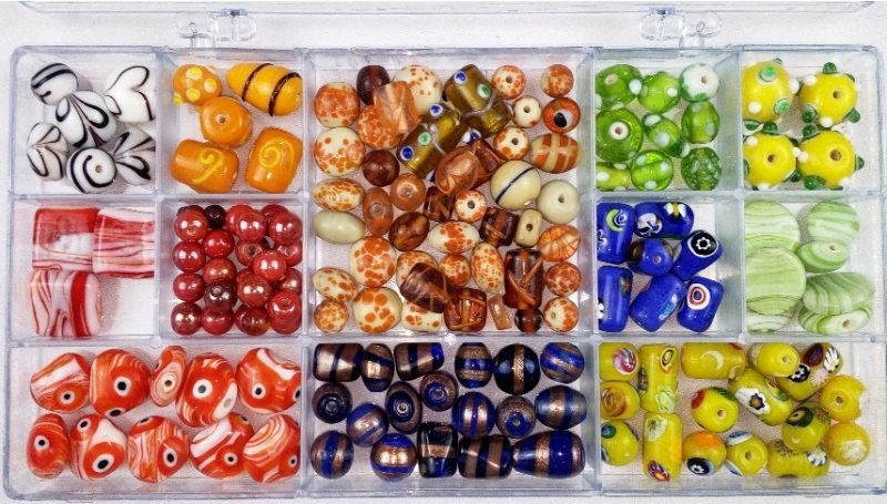 Glass beads arranged by colour and pattern